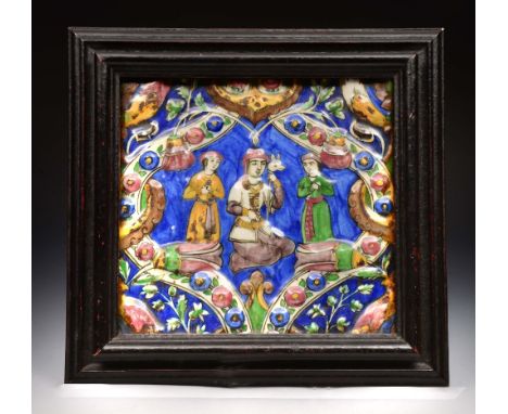 A PERSIAN QAJAR SQUARE POTTERY TILE with polychrome enamel decoration of three figures within a cartouche, 20cm