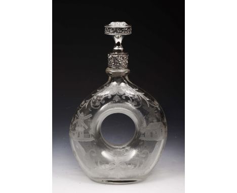 A LATE 19TH DUTCH GLASS LOOP DECANTER engraved with houses, windmills and scrolling foliage, the white metal mount and stoppe