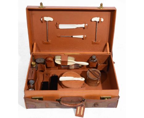 A LEATHER GENTLEMANS DRESSING CASE containing an assortment of fittings including a set of razors in case; silver and silver 