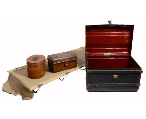A CANVAS AND METAL FOLDING CAMP BED; a painted tin hat box; a dome top metal deed box; and a painted tin travelling trunk (4)