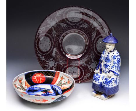 A CHINESE PORCELAIN BLUE AND WHITE SEATED FIGURE, 50cm high; an Imari porcelain circular bowl, 24cm diameter; and a ruby and 