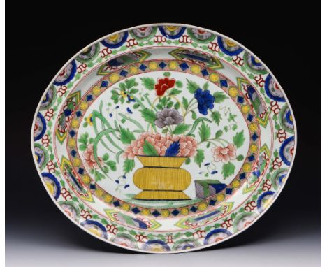 A CHINESE FAMILLE VERTE ENAMEL OVAL PORCELAIN SERVING DISH decorated with a vase of summer flowers, 47cm wide