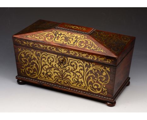 A GEORGE IV ROSEWOOD AND BRASS INLAID TEA CADDY of sarcophagus form, the interior fitted with two removable lidded compartmen