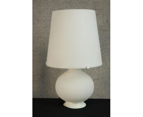 A contemporary white glass table lamp raised on spherical bulbus base. H.53cm. 