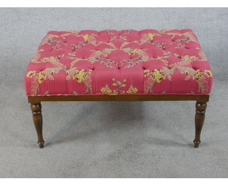 A 20th century mahogany framed button upholstered footstool raised on turned supports. H.47 W.93 D.68cm 