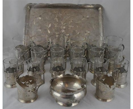 An Islamic&nbsp;white metal part tea service, to include&nbsp;serving tray, sugar&nbsp;and six glass sleeves, all with engrav
