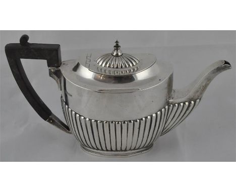 An Edwardian silver teapot, by Fordham &amp; Faulkner, Sheffield 1902, of oval form with semi-fluted decoration and ebony han