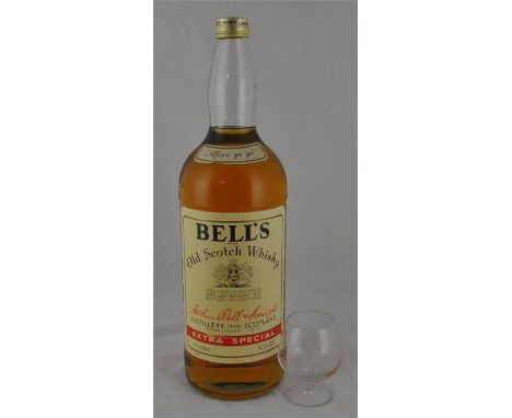 A 4.5 litre bottle of Bell's Old Scotch Whisky, together with a whisky glass. (2)&nbsp;