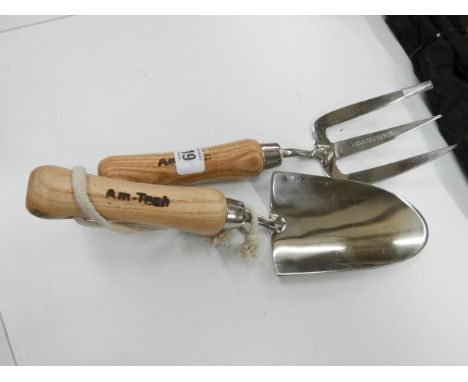 A stainless steel hand trowel and hand fork