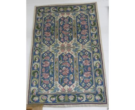 An Aubusson style floral patterned tapestry wall hanging and a smaller flower decorated wall hanging 