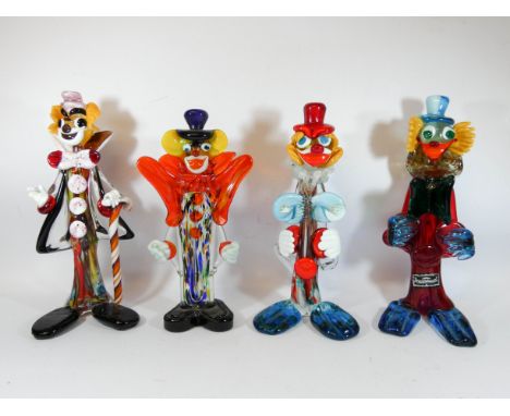 A group of four Murano and end of day glass clowns one with a candy cane walking stick, tallest measures 28cm 