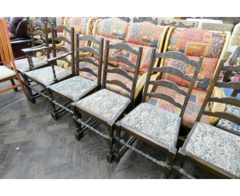 A set of four oak ladder back dining room chairs with tapestry seats and a pair of carvers 