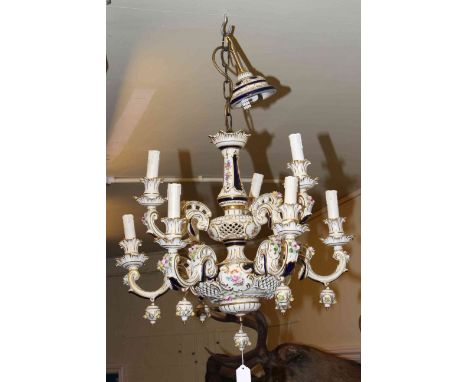 German porcelain floral encrusted nine branch centre ceiling light with pierced and gilt decoration