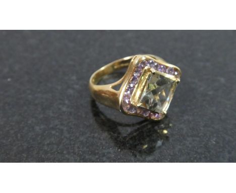 A 9ct Gold Amethyst and Green Topaz Dress Ring, 4.1gms 