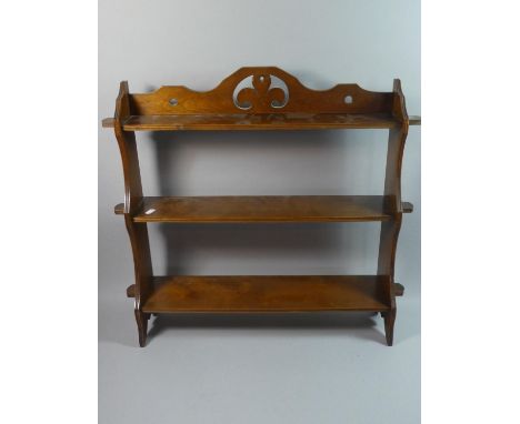 A Wooden Wall Hanging Three Shelf Unit with Fleur De Lys Decoration to Top Rail, 63cms Wide 