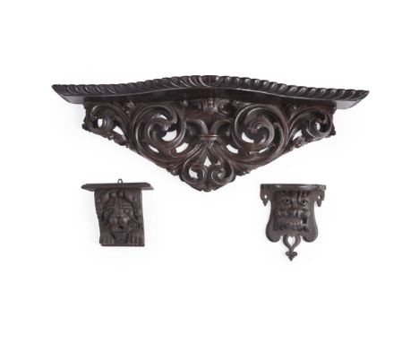 FIVE BAROQUE STYLE CARVED WOOD WALL MOUNTS  LATE 19TH/ EARLY 20TH CENTURY   comprising a serpentine shelf carved with leaf sc