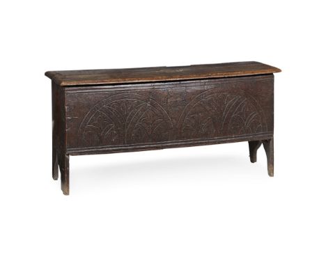 ELM BOARD CHEST  LATE 17TH CENTURY   the hinged top over a front panel carved with arched reserves and stylised plant motifs,