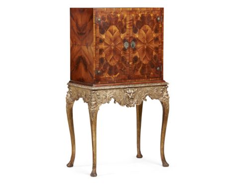 GEORGE I STYLE OYSTER VENEERED AND PARCEL GILT CABINET ON STAND  EARLY 20TH CENTURY   of cubic form, the oyster veneered door