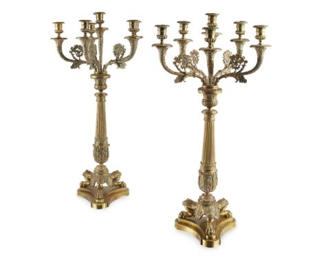 PAIR OF EMPIRE STYLE BRASS CANDELABRA  LATE 19TH/ EARLY 20TH CENTURY   the knopped and reeded tapered stems issuing a stiff a