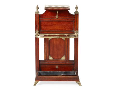 VICTORIAN MAHOGANY AND BRASS STICK STAND BY JAMES SHOOLBRED & CO.  19TH CENTURY   the panelled back with brass gallery, finia