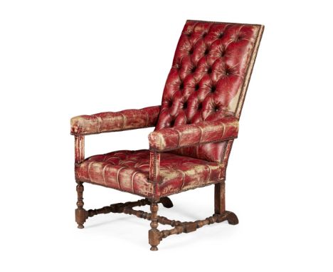 LEATHER UPHOLSTERED WALNUT ARMCHAIR  the rectangular back above straight open arms and wide seat, all in red button upholster