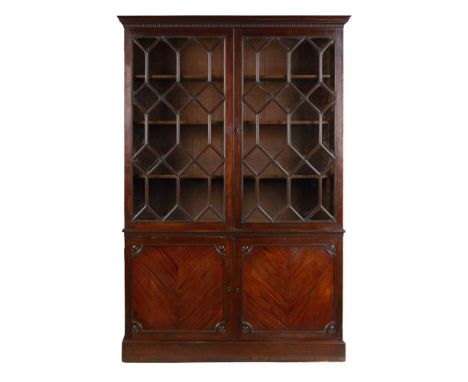 GEORGE III MAHOGANY BOOKCASE CABINET  18TH CENTURY, LATER ADAPTED   the dentil moulded cornice above a pair of astragal glaze