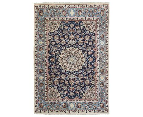 ISFAHAN RUG  CENTRAL PERSIA, 20TH CENTURY   the indigo field with cream medallion, similar spandrels, within light blue palme