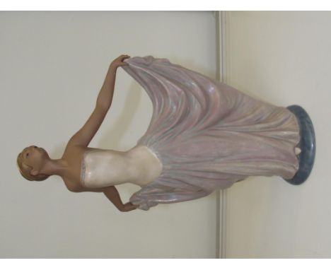 Lladro bisque figure, modelled as a dancer with outstretched arms lifting her gown, height 32cm