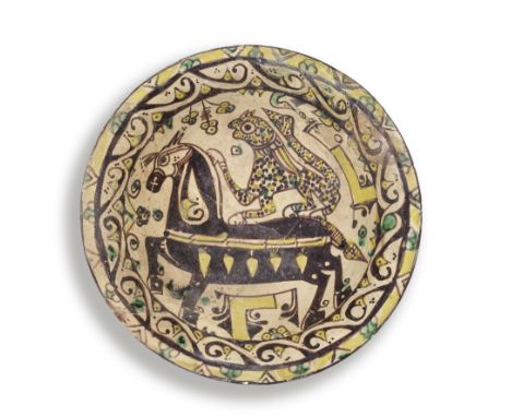 A Nishapur buffware pottery bowl Persia, 10th Centuryof shallow rounded form on a short foot with everted rim, decorated unde