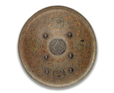 A Qajar painted hide shield (dhal) Persia, dated AH 1336/ AD 1917-18of convex form with everted rim, six applied steel bosses