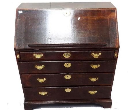 Georgian Oak Bureau with fall enclosing small serpentine fronted draws, central cupboard with pigeon holes & secret compartme