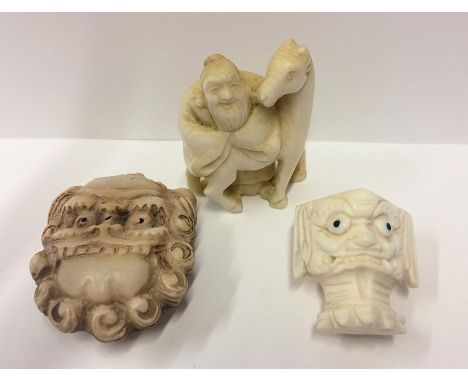 Carved Ivory Netsuke Man leaning on the back of a horse, Mask Style Netsuke signed to rear & Grotesque Head (3) 