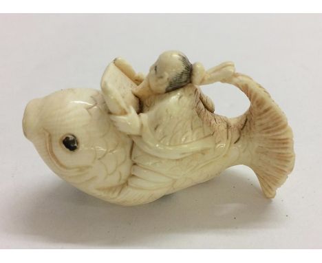 Carved Ivory Netsuke Man reading from scroll astride a carp, signed 