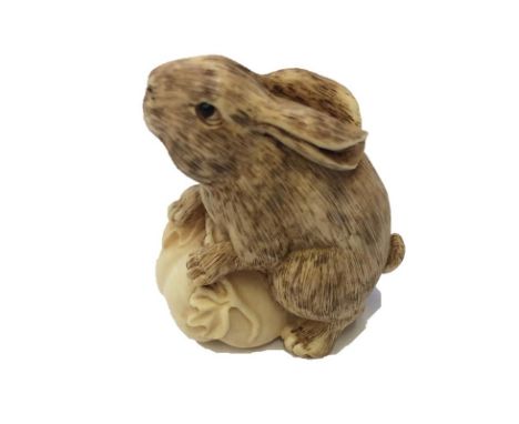 Netsuke with textured hare on fruit gourd signed to base 