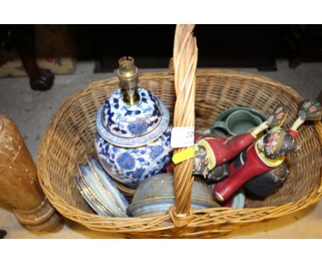 A basket containing a blue and white table lamp base; two figures etc. 