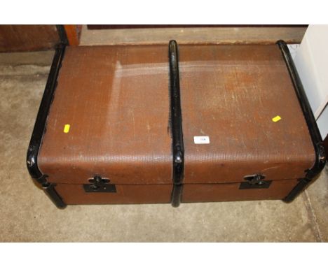 A wooden bound travelling trunk and a leather suitcase
