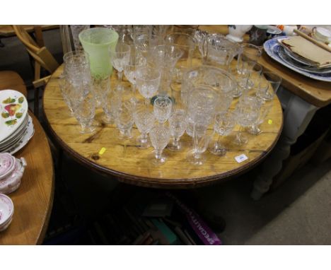 A pine circular topped kitchen table with two stick back chairs 