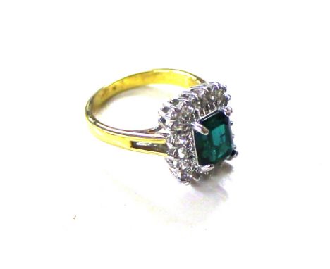 A yellow metal green stone set ring