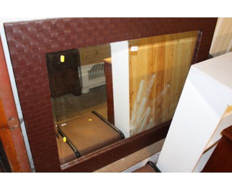 A large wall mirror with leather surround