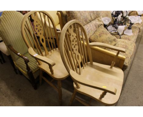 A pair of beech stick and wheel back elbow armchair 