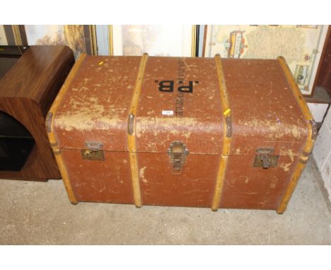 A large wooden bound travelling trunk