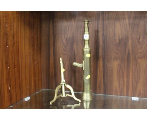 A SMALL VINTAGE BRASS TELESCOPE ON STAND