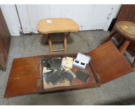 A MAHOGANY BOX CONTAINING MAGIC LANTERN SLIDES TOGETHER WITH A SMALL FOLDING STOOL