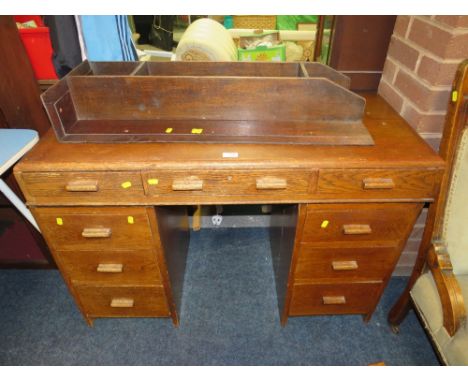 A VINTAGE UTILITY / RETRO STYLE SMALL OAK DESK, H 76 CM, W 110 CM, TOGETHER WITH AN OAK WALL SHELF