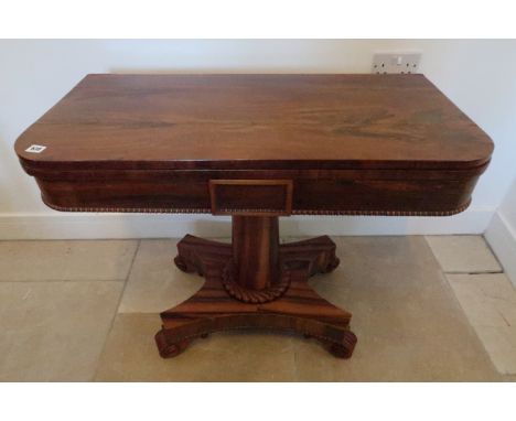 A 19th century rosewood fold over card table
