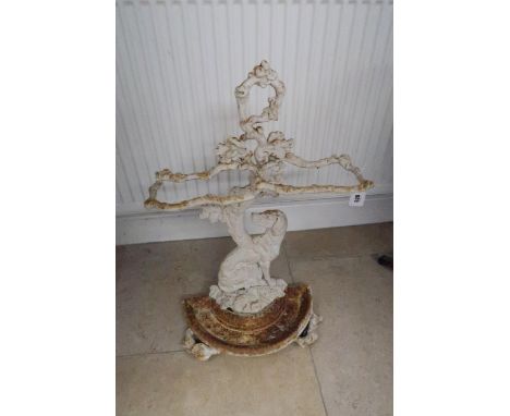 A Coalbrookdale style cast iron stick stand, modelled with a dog sat by a tree, with naturalistic branch holders and detailin