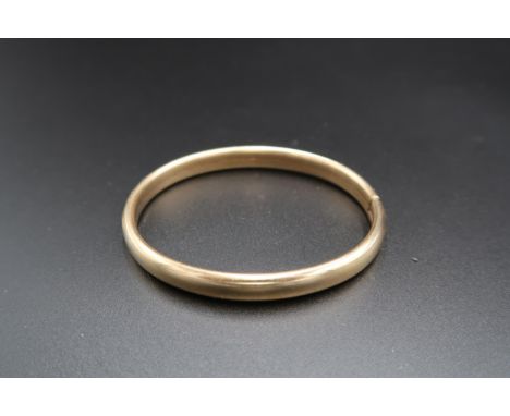 A 9ct gold smooth bangle. Weight 10.98 grams
