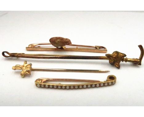 A group of four bar brooches or stock pins, comprising a 15ct gold plated bar brooch with chick detail, another unmarked set 