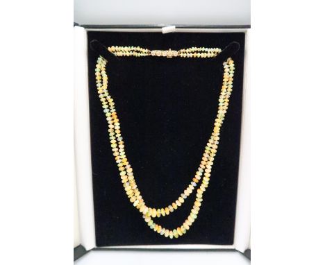 An opal beaded double strand necklace, with 18ct gold and diamond five stone clasp, total length 45cm, weight 22.8g.