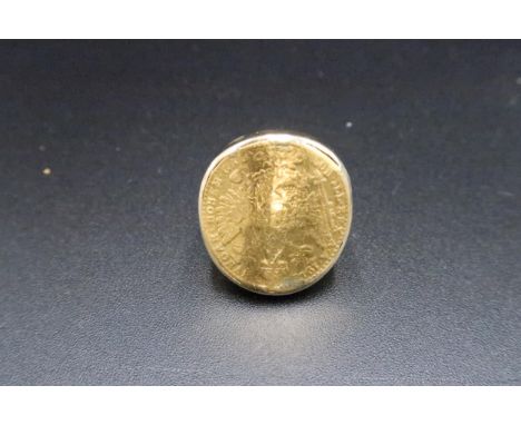 A coin ring. Tests 14 and 22ct gold. Size K. Weight 10.45 grams